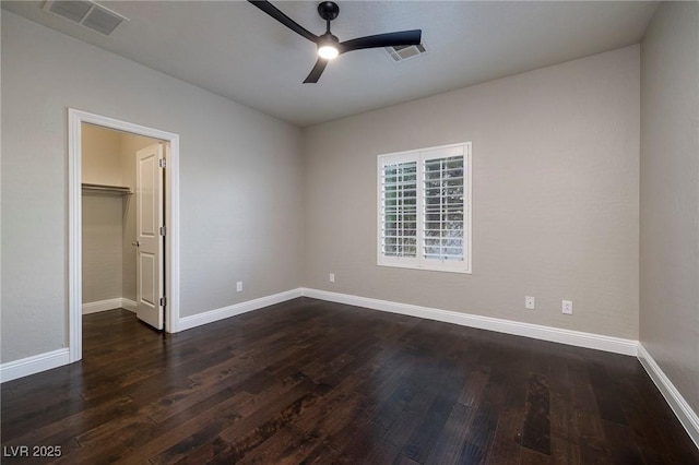 2900 Valvent Ct, Henderson, NV 89044 - unfurnished bedroom with dark wood-type flooring, a spacious closet, baseboards, a ceiling fan, and a closet