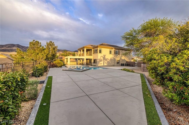 2900 Valvent Ct, Henderson, NV 89044 - rear view of house with a patio, a pool with connected hot tub, stucco siding, and a tiled roof
