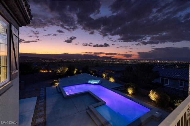 2900 Valvent Ct, Henderson, NV 89044 - pool at dusk with a pool with connected hot tub and a patio