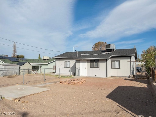 26 E Atlantic Ave, Henderson, NV 89015 - rear view of house featuring fence, central AC unit, and roof with shingles