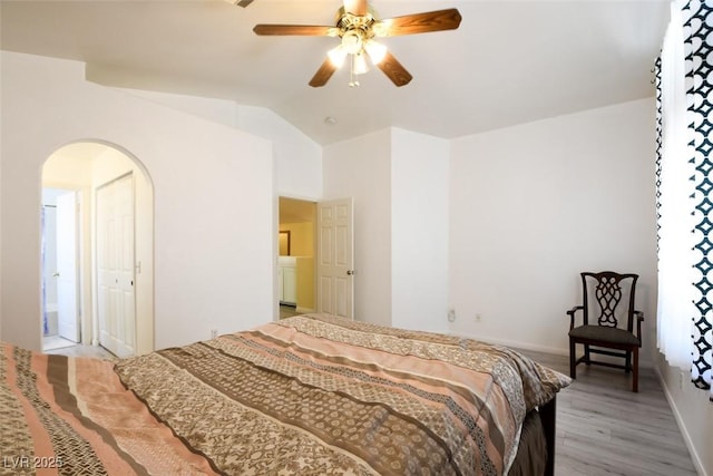 8370 Lost Lake Ct, Las Vegas, NV 89147 - bedroom with light wood-type flooring, arched walkways, lofted ceiling, ceiling fan, and baseboards