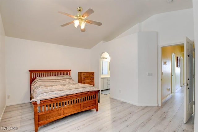 8370 Lost Lake Ct, Las Vegas, NV 89147 - bedroom with light wood-style flooring, arched walkways, a ceiling fan, connected bathroom, and high vaulted ceiling