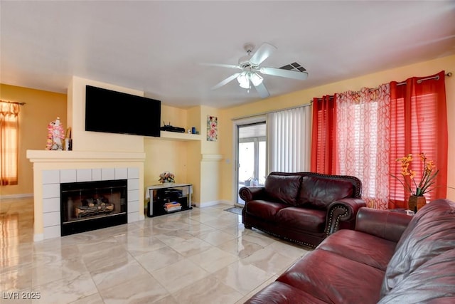 8370 Lost Lake Ct, Las Vegas, NV 89147 - living room with a ceiling fan, marble finish floors, a tiled fireplace, and baseboards