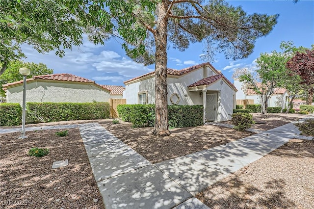 5401 Bugle Way Unit 103, Las Vegas, NV 89108 - view of side of property featuring stucco siding, a tile roof, and fence