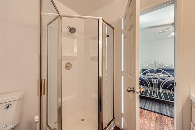 5401 Bugle Way Unit 103, Las Vegas, NV 89108 - full bathroom with a shower stall, wood finished floors, toilet, and ceiling fan
