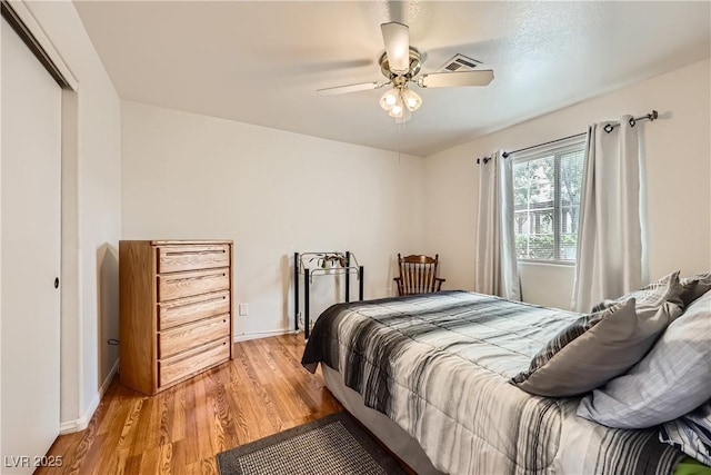 5401 Bugle Way Unit 103, Las Vegas, NV 89108 - bedroom with light wood-style flooring, a ceiling fan, baseboards, and a closet