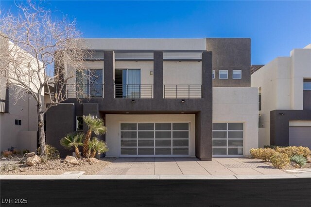 2672 Mystere Ct, Las Vegas, NV 89117 - contemporary home with a balcony, an attached garage, stucco siding, and driveway