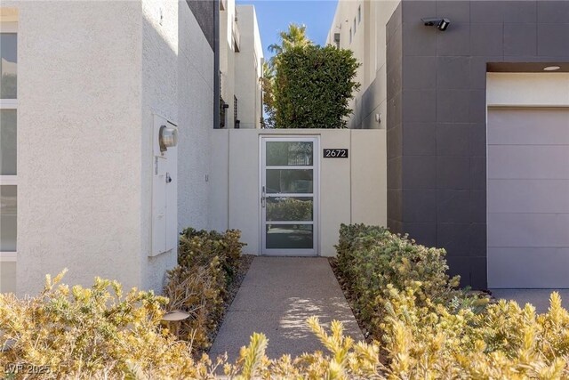 2672 Mystere Ct, Las Vegas, NV 89117 - entrance to property with a garage and stucco siding