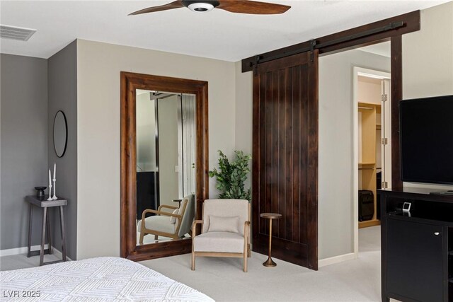 2672 Mystere Ct, Las Vegas, NV 89117 - bedroom with light colored carpet, a barn door, and ceiling fan