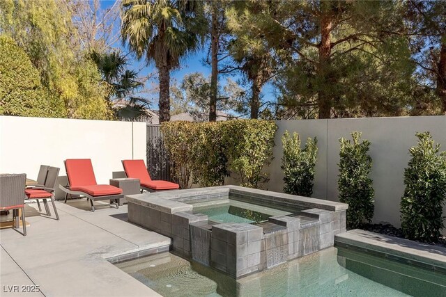 2672 Mystere Ct, Las Vegas, NV 89117 - view of pool featuring an in-ground hot tub, a fenced backyard, and a patio area