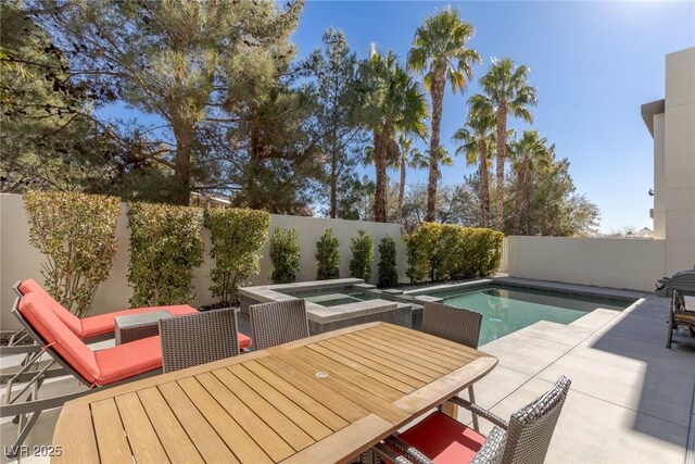 2672 Mystere Ct, Las Vegas, NV 89117 - view of pool with a patio area, a fenced backyard, outdoor dining space, and an in-ground hot tub