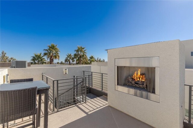 2672 Mystere Ct, Las Vegas, NV 89117 - view of patio with a warm lit fireplace