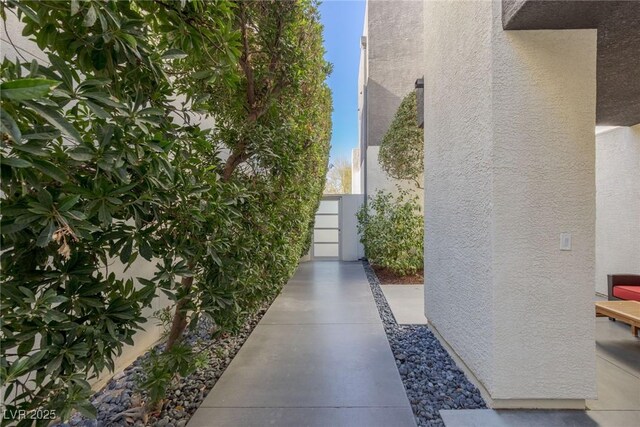 2672 Mystere Ct, Las Vegas, NV 89117 - view of side of property featuring stucco siding and a gate