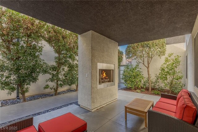 2672 Mystere Ct, Las Vegas, NV 89117 - view of patio with an outdoor living space with a fireplace