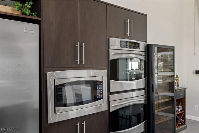 2672 Mystere Ct, Las Vegas, NV 89117 - kitchen featuring appliances with stainless steel finishes and dark brown cabinets