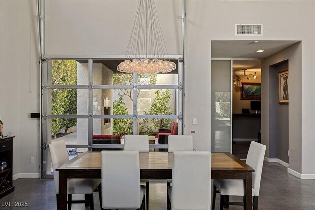 2672 Mystere Ct, Las Vegas, NV 89117 - dining area with a chandelier and finished concrete flooring