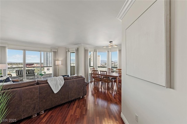 2777 Paradise Rd Unit 1105, Las Vegas, NV 89109 - living area featuring dark wood finished floors, plenty of natural light, crown molding, and a ceiling fan
