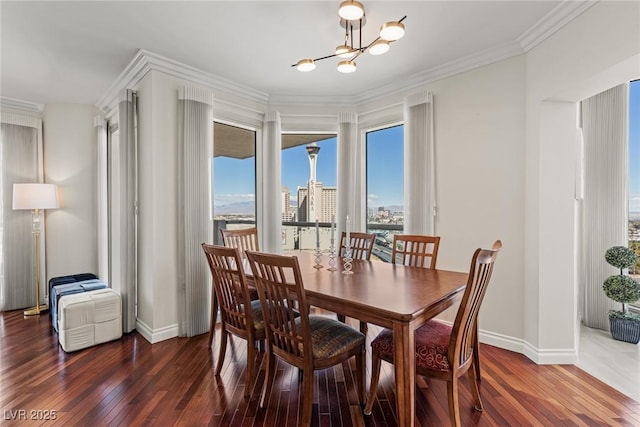 2777 Paradise Rd Unit 1105, Las Vegas, NV 89109 - dining space with a chandelier, wood-type flooring, baseboards, and ornamental molding