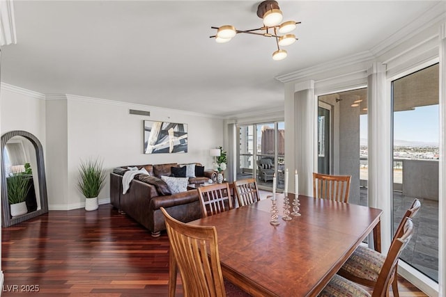 2777 Paradise Rd Unit 1105, Las Vegas, NV 89109 - dining area with a chandelier, wood finished floors, baseboards, and ornamental molding