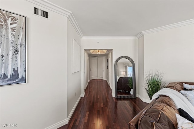 hallway featuring crown molding, baseboards, and hardwood / wood-style flooring