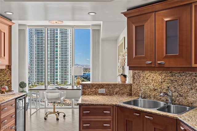 2777 Paradise Rd Unit 1105, Las Vegas, NV 89109 - kitchen featuring a sink, wine cooler, tasteful backsplash, light stone countertops, and recessed lighting