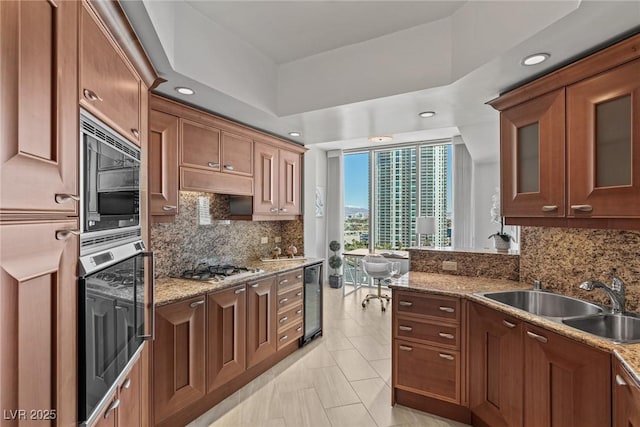 kitchen featuring a sink, wine cooler, appliances with stainless steel finishes, decorative backsplash, and recessed lighting