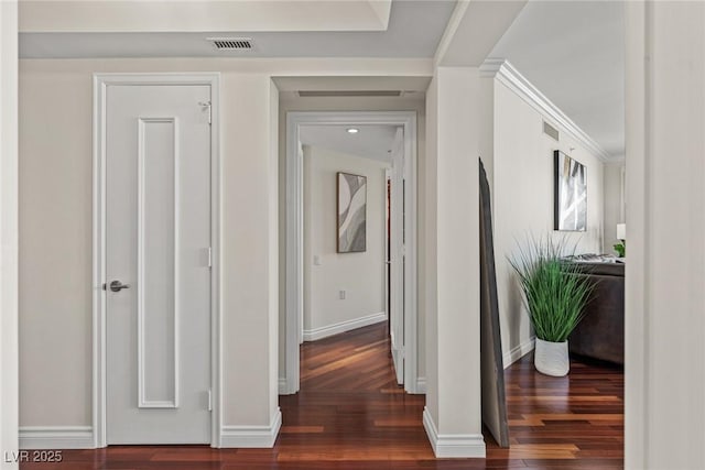 hall featuring baseboards and wood finished floors