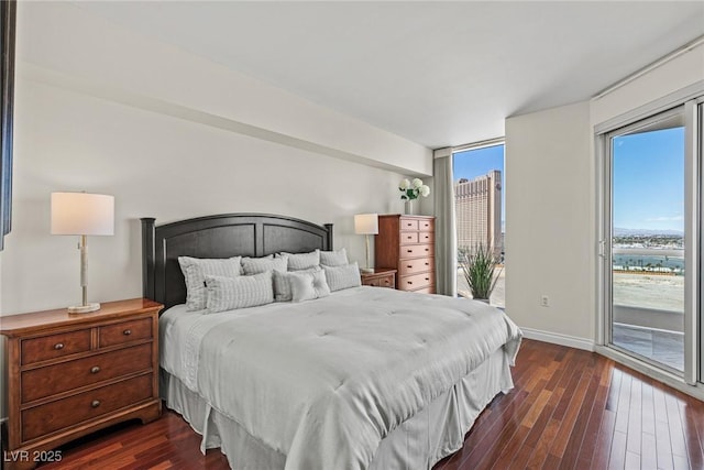 bedroom featuring access to outside, dark wood finished floors, and baseboards