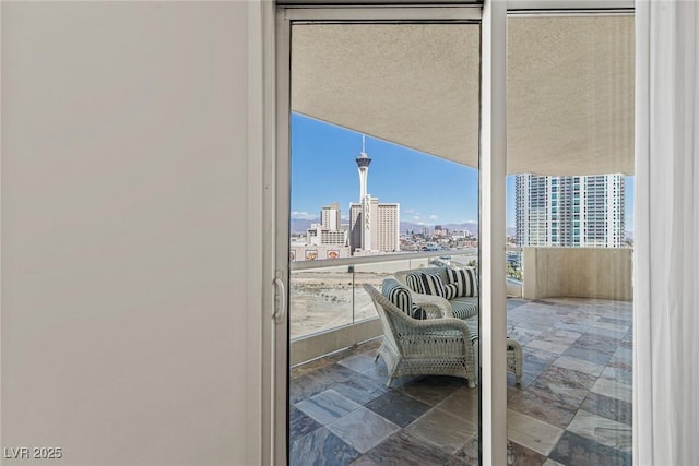 entryway with a view of city, plenty of natural light, and stone finish floors
