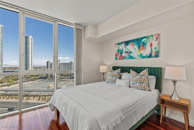 2777 Paradise Rd Unit 1105, Las Vegas, NV 89109 - bedroom with floor to ceiling windows, wood finished floors, and a view of city
