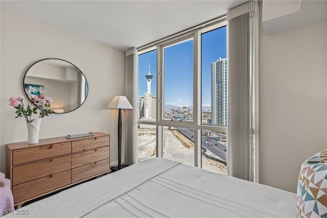 bedroom featuring a city view and expansive windows