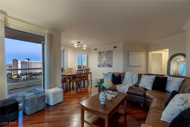 living area with crown molding, hardwood / wood-style floors, plenty of natural light, and a ceiling fan