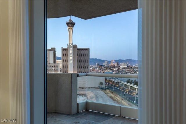 balcony with a city view and a mountain view
