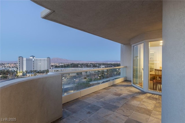 balcony featuring a mountain view and a view of city