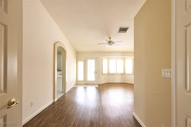 6016 Bungalow Bay St, Las Vegas, NV 89130 - unfurnished room featuring ceiling fan, baseboards, arched walkways, and dark wood-type flooring
