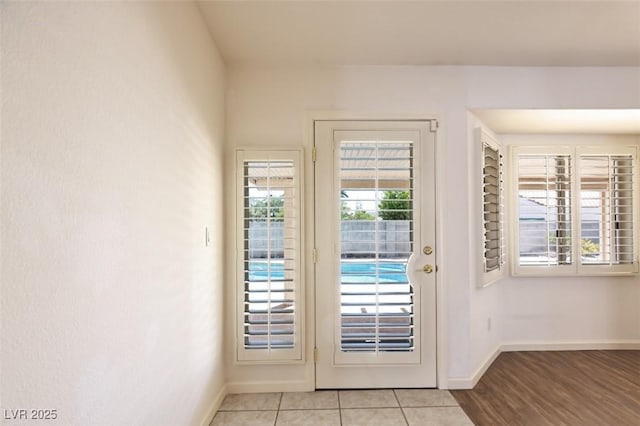 6016 Bungalow Bay St, Las Vegas, NV 89130 - doorway to outside featuring baseboards and light tile patterned floors