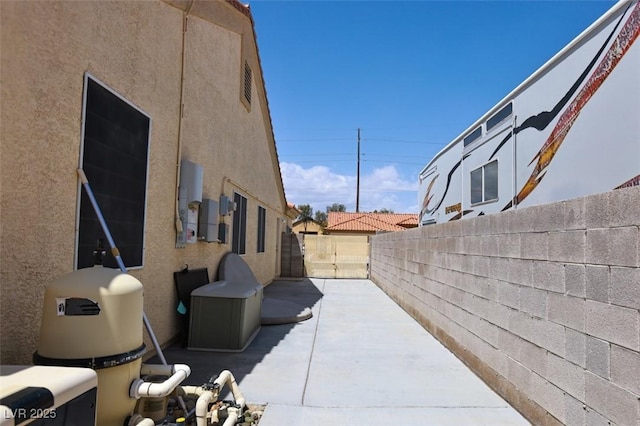 6016 Bungalow Bay St, Las Vegas, NV 89130 - view of property exterior featuring fence, a patio, and stucco siding