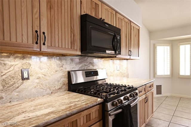 6016 Bungalow Bay St, Las Vegas, NV 89130 - kitchen featuring stainless steel gas range oven, black microwave, decorative backsplash, baseboards, and light tile patterned floors
