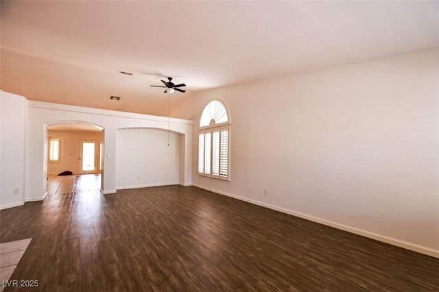6016 Bungalow Bay St, Las Vegas, NV 89130 - empty room with healthy amount of natural light, a ceiling fan, arched walkways, dark wood-type flooring, and lofted ceiling
