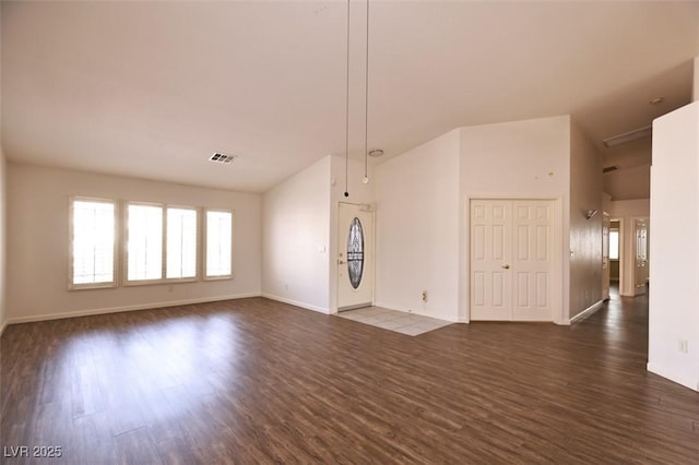 6016 Bungalow Bay St, Las Vegas, NV 89130 - unfurnished living room with dark wood finished floors, baseboards, and high vaulted ceiling