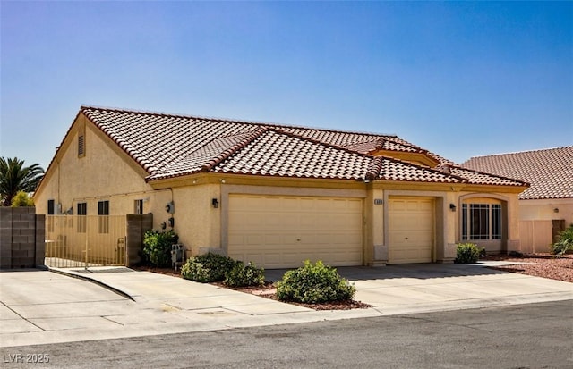 6016 Bungalow Bay St, Las Vegas, NV 89130 - mediterranean / spanish-style home featuring stucco siding, a garage, driveway, and a tile roof