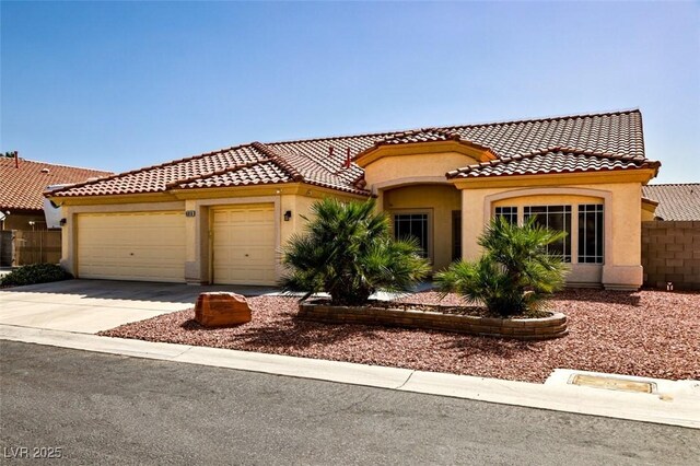 6016 Bungalow Bay St, Las Vegas, NV 89130 - mediterranean / spanish home with a garage, stucco siding, driveway, a tile roof, and fence