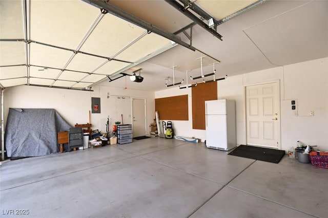 6016 Bungalow Bay St, Las Vegas, NV 89130 - garage with freestanding refrigerator, electric panel, and a garage door opener