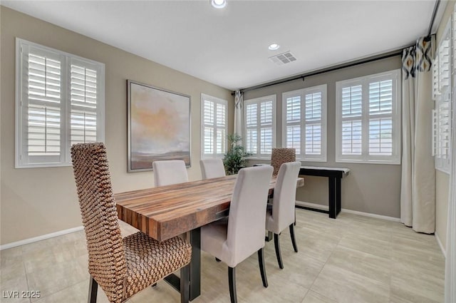 dining area with baseboards, light tile patterned flooring, and recessed lighting