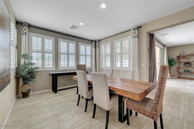 dining space with baseboards, light tile patterned flooring, and recessed lighting