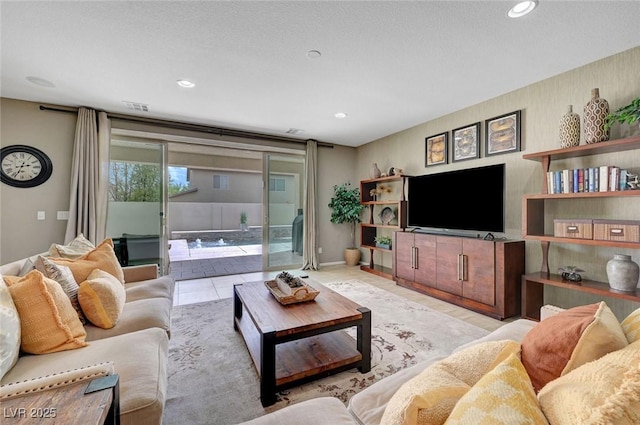 living area featuring recessed lighting and baseboards