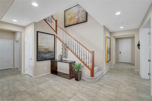 foyer with stairs, baseboards, and recessed lighting