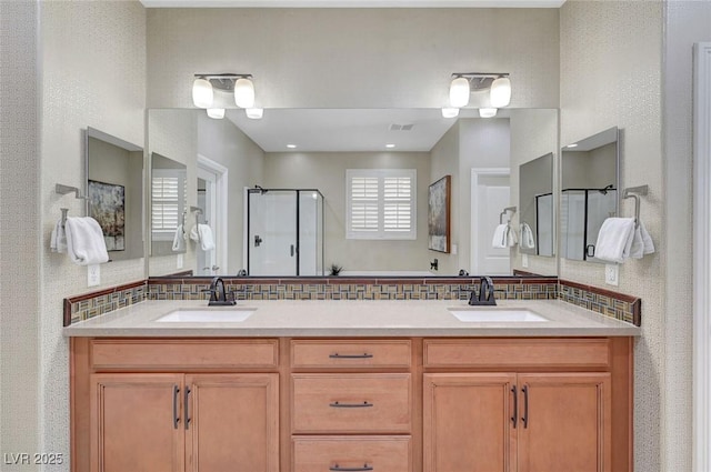 full bathroom featuring a stall shower, decorative backsplash, and double vanity