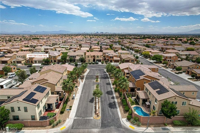 aerial perspective of suburban area featuring a pool and mountains