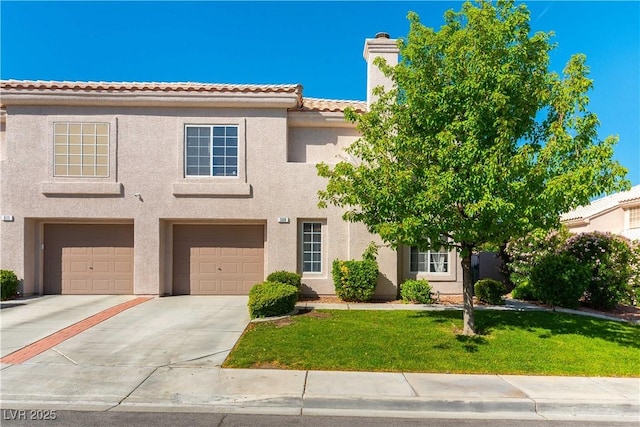 view of front of home featuring concrete driveway, stucco siding, an attached garage, a front yard, and a chimney